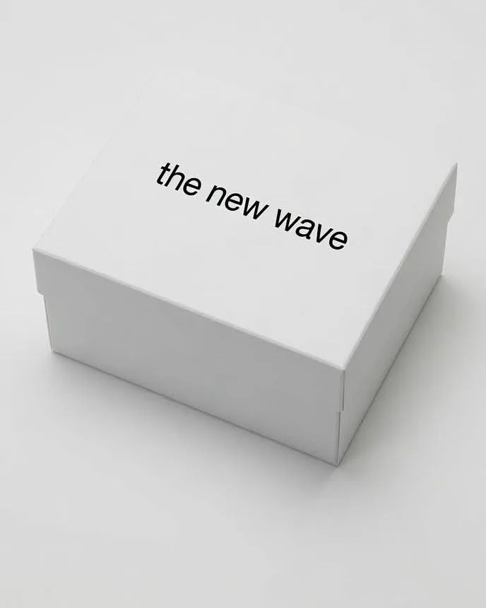 Closed white presentation box with the new wave on the lid