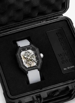 Project 2 with the grey strap in its black presentation case, beside the numbered the new wave plate