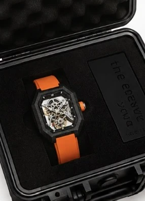 Project 2 with the orange strap in its black presentation case, beside the numbered the new wave plate