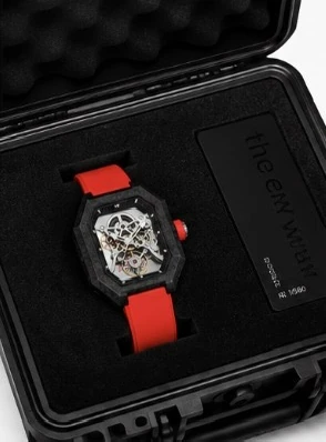 Project 2 with the red strap in its black presentation case, beside the numbered the new wave plate